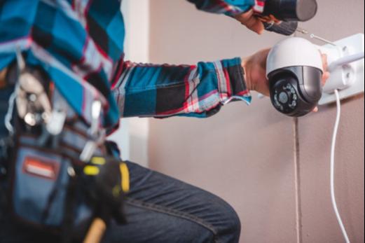 Worker installing a CCTV camera