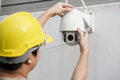 Technician re-installing the CCTV camera after maintenance